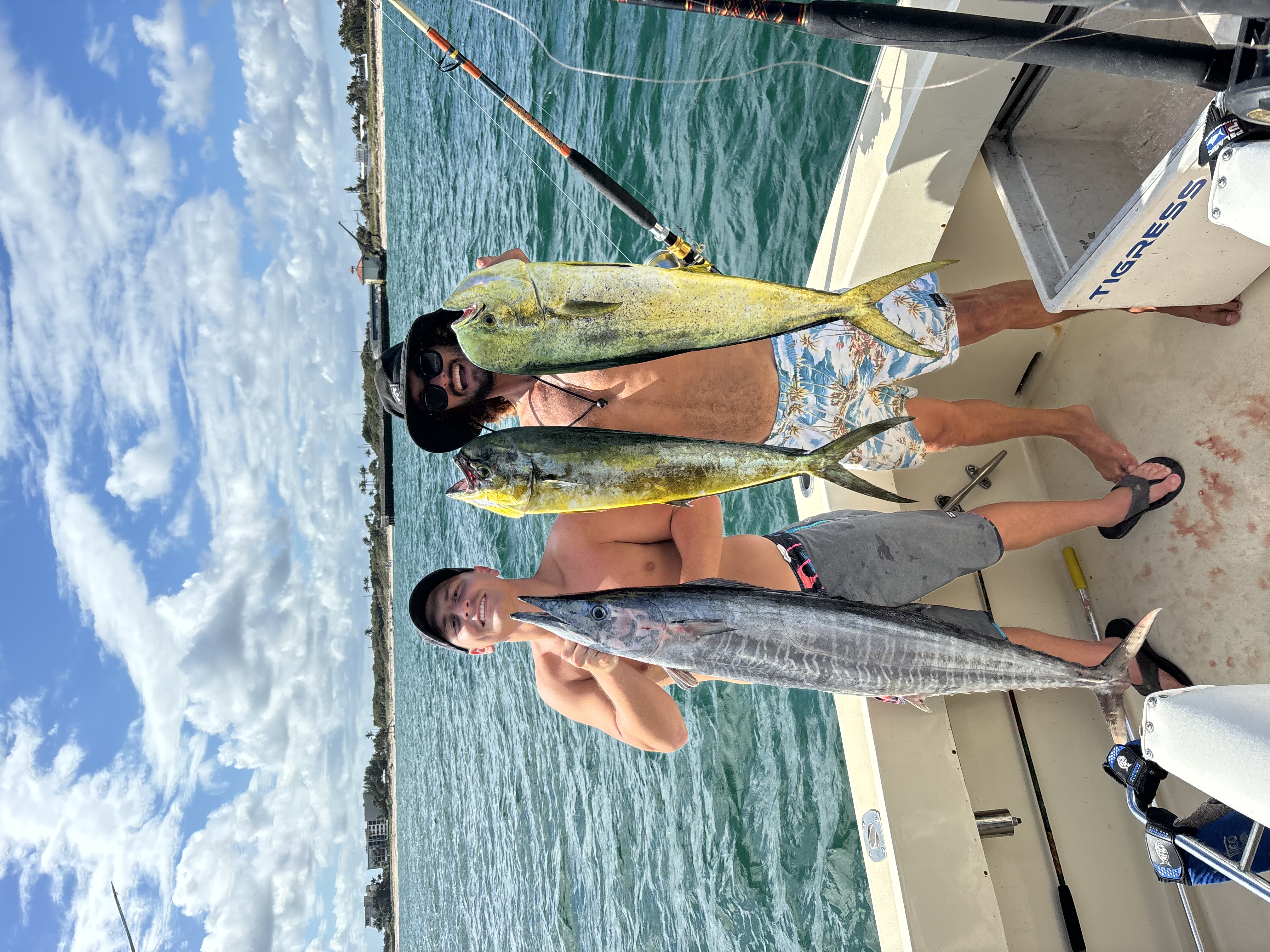 Happy customer with a catch on a Frigate About It fishing charter